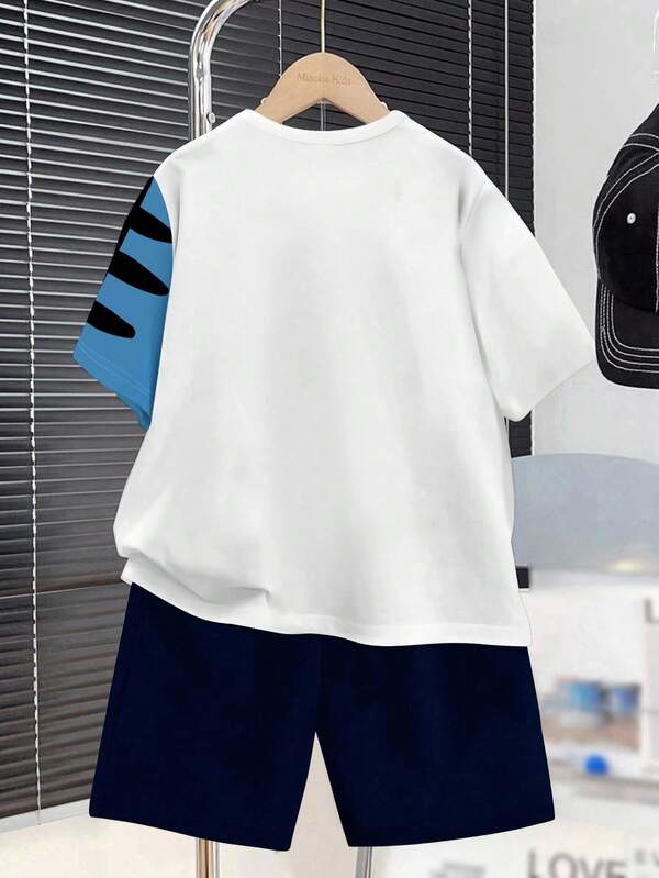 Lässiges Teenager-Jungen-Set mit Cartoon-Dinosaurier-Aufdruck, Rundhals-Kurzarm-T-Shirt und Shorts im 2er-Set für den Sommer Lässiges Teenager-Jungen-Set mit Cartoon-Dinosaurier-Aufdruck, Rundhals-Kurzarm-T-Shirt und Shorts im 2er-Set für den Sommer